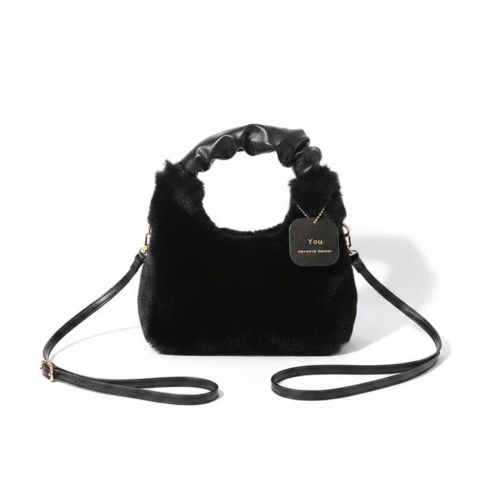 Black faux fur shoulder bag flat lay on white background