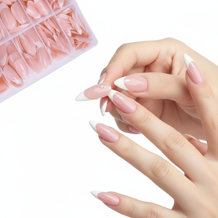 Woman applying almond French tip press-on nail to finger